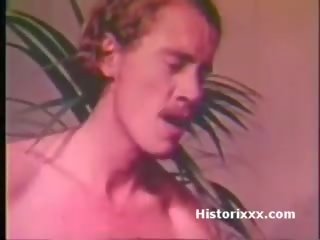 Busty divinity sucks huge manhood and gets facial in vintage video