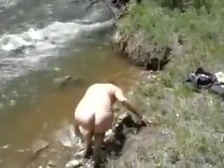Morgan taking a bath in a river